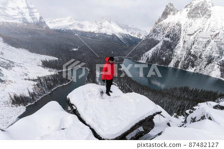 Traveler man in red jacket standing on peak of Opabin Plateau in blizzard at Yoho national park Traveler man in red jacket standing on peak of Opabin Plateau in blizzard at Yoho national park 87482127