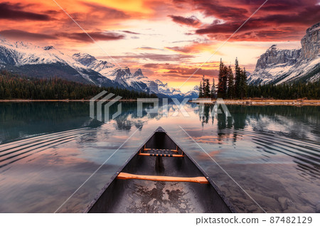 Spirit Island with canoe and colorful sky over canadian rockies on Maligne Lake in the sunset at Jasper national park 87482129