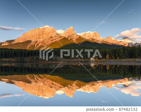 Sunrise on Mount Rundle with blue sky reflection on Rundle Forebay reservoir in autumn at Canmore Sunrise on Mount Rundle with blue sky reflection on Rundle Forebay reservoir in autumn at Canmore 87482132