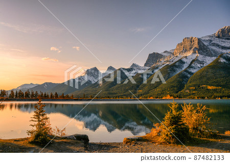 Sunrise on Mount Rundle with blue sky reflection on Rundle Forebay reservoir in autumn at Canmore Sunrise on Mount Rundle with blue sky reflection on Rundle Forebay reservoir in autumn at Canmore 87482133