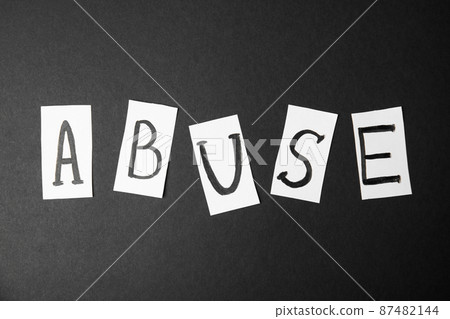 Word ABUSE on black background, top view. Domestic violence awareness Word ABUSE on black background, top view. Domestic violence awareness 87482144