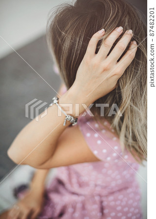 portrait of a beautiful woman a light violet sundress. vacation, enjoys life. delicate hand 87482201