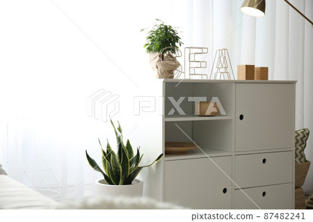 Chest of drawers in stylish room interior 87482241