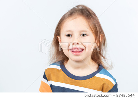 Little girl shows myofunctional trainer. dental tariner is made to correct bite Little girl shows myofunctional trainer. dental tariner is made to correct bite 87483544