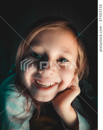 Little Caucasian girl smiling and looking at camera 87483556