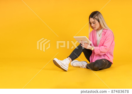 young caucasian woman checking email on tablet young caucasian woman checking email on tablet 87483678