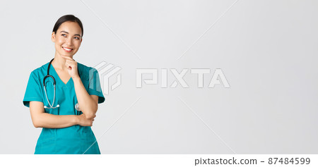 Covid-19, healthcare workers, pandemic concept. Smiling pleased attractive asian female doctor in scrubs, looking upper left corner and thinking, have idea, standing thoughtful white background Covid-19, healthcare workers, pandemic concept. Smiling pleased attractive asian female doctor in scrubs, looking upper left corner and thinking, have idea, standing thoughtful white background 87484599