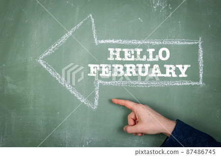 Hello February. Direction arrow on a green chalk board Hello February. Direction arrow on a green chalk board 87486745