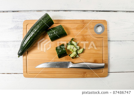 Sliced long cucumber on a bamboo wooden board Sliced long cucumber on a bamboo wooden board 87486747