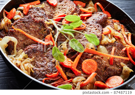 Chicken liver fritters on a baking dish with sage Chicken liver fritters on a baking dish with sage 87487119