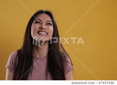 Young satisfied woman beams with happiness 87487486