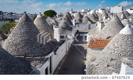 Famous Trulli houses in the city of Alberobello in Italy 87487629