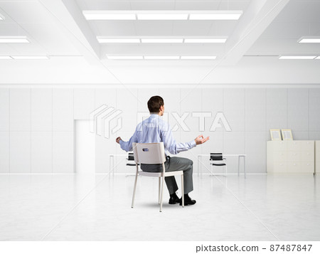 young businessman meditating in the office young businessman meditating in the office 87487847