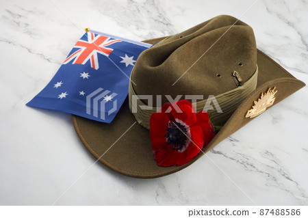 Anzac army slouch hat with Australian Flag and Poppy on stone background Anzac army slouch hat with Australian Flag and Poppy on stone background 87488586