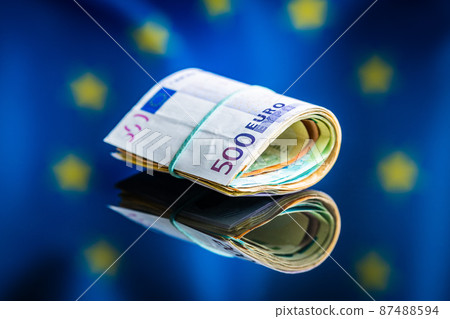 Euro banknotes in front of Europe union flag. Paper European currency. 87488594