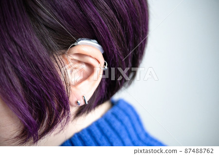 Fashionable woman with hearing aids Fashionable woman with hearing aids 87488762