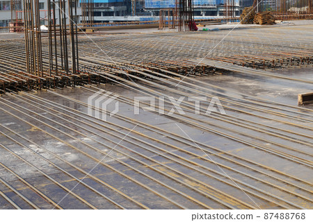 PENANG, MALAYSIA -MARCH 4, 2020: Floor slabs are under construction at a construction site. Workers were busy installing steel reinforcement on the timber formwork before concrete was poured on it. 87488768