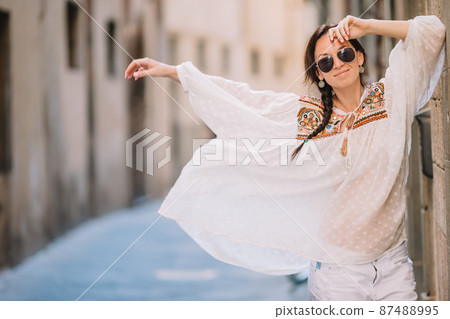 Young woman walking along the deserted streets of Europe. 87488995