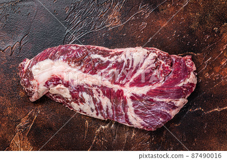 Raw hanging tender or onglet beef meat steak. Dark background. Top View 87490016