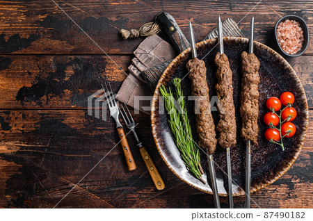 Grilled Shish kebab on skewers from minced lamb beef meat, Lula kebab. Wooden background. Top view. Copy space Grilled Shish kebab on skewers from minced lamb beef meat, Lula kebab. Wooden background. Top view. Copy space 87490182