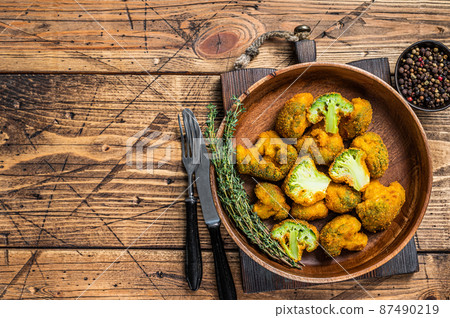 Breadcrumb broccoli in a wooden plate with thyme. wooden background. Top view. Copy space 87490219