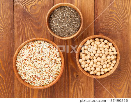 Healthy super food - dry chickpeas, quinoa, chia on brown wooden background, top view 87490236