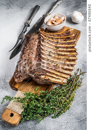 Charcoal Grilled French rack of Lamb Ribs Chops on cutting board. White background. Top view Charcoal Grilled French rack of Lamb Ribs Chops on cutting board. White background. Top view 87490848