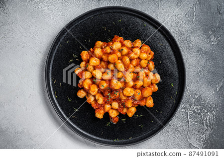Gnocchi potato pasta with tomato sauce. White background. Top view. Copy space Gnocchi potato pasta with tomato sauce. White background. Top view. Copy space 87491091