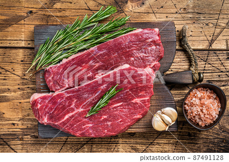 Raw rump cap steak or Picanha steak on wooden board with butcher knife. wooden background. Top view Raw rump cap steak or Picanha steak on wooden board with butcher knife. wooden background. Top view 87491128