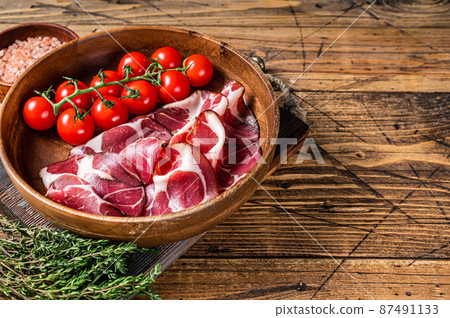 Italian sliced cured coppa ham with spices. wooden background. Top view. Copy space 87491133