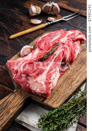 Raw Boneless lamb meat, raw neck meat on wooden board. Black background. Top view Raw Boneless lamb meat, raw neck meat on wooden board. Black background. Top view 87491241