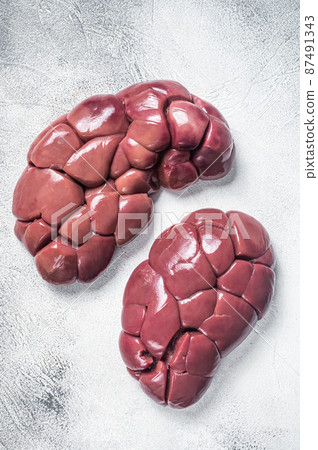 Raw Beef kidney on butcher table. White background. Top view Raw Beef kidney on butcher table. White background. Top view 87491343