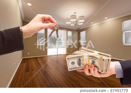 Agent Handing Over House Keys for Cash in Newly Remodeled Room of House. Agent Handing Over House Keys for Cash in Newly Remodeled Room of House. 87491779