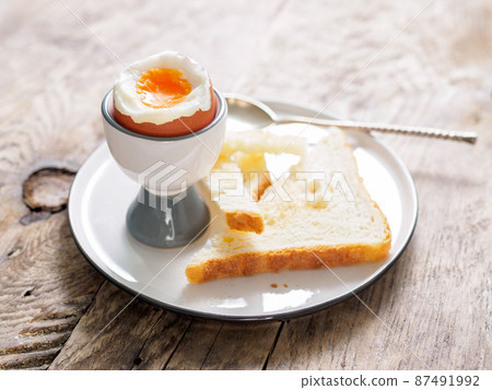 soft boiled egg in Cup on a wooden table soft boiled egg in Cup on a wooden table 87491992