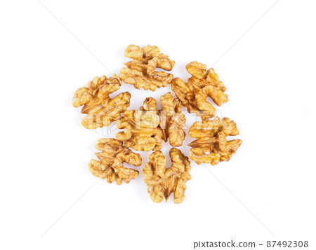 Top view with a handful of walnut, circassian nuts isolated on white background Top view with a handful of walnut, circassian nuts isolated on white background 87492308