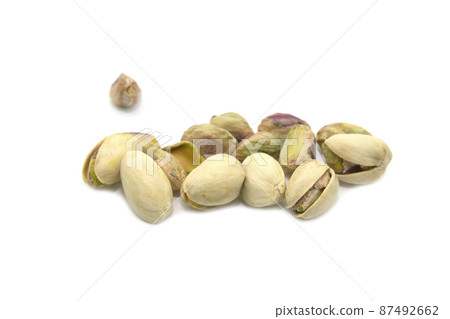 Green pistachios isolated on a white background. 87492662