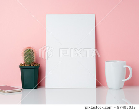 Blank white frame and plant cactus, cup of coffee or tea on a white table against the pink wall with copy space. Mockup with copy space. Blank white frame and plant cactus, cup of coffee or tea on a white table against the pink wall with copy space. Mockup with copy space. 87493032