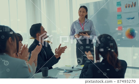Business people in corporate staff meeting with envisional graphic Business people in corporate staff meeting with envisional graphic 87493270