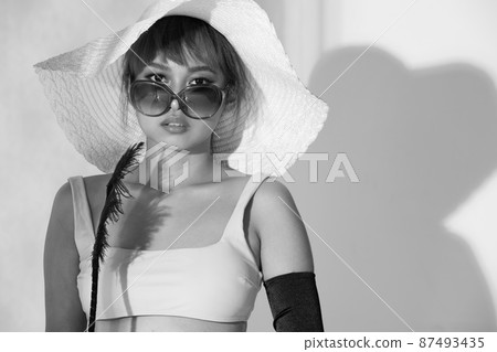 Half body Asian Woman 20s wear Bikini sunglasses beach hat and gloves stay in sun and reflect 87493435