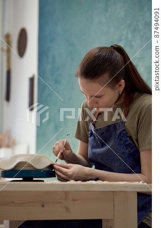 Young girl making ceramic bowl in class. Creative hobby concept 87494091