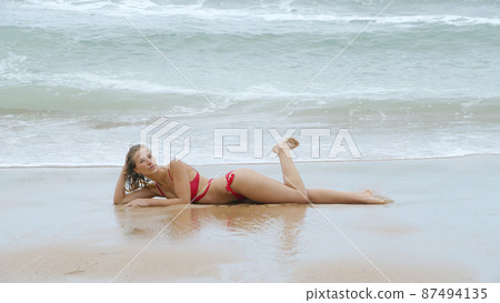 Sexy girl poses for the camera - happy girl on summer vacation at the beach Sexy girl poses for the camera - happy girl on summer vacation at the beach 87494135