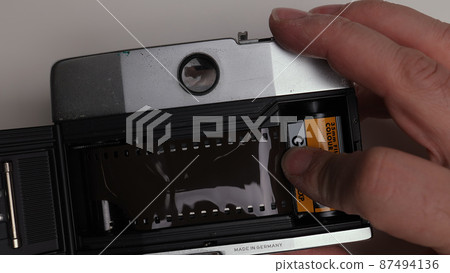 Loading a negative film into a camera Loading a negative film into a camera 87494136