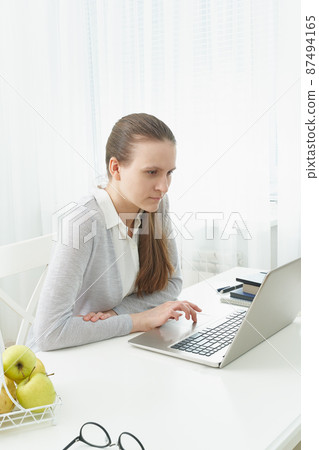 Distance education for students. Quarantine, self-isolation, sociophobia. Young girl listens Distance education for students. Quarantine, self-isolation, sociophobia. Young girl listens 87494165