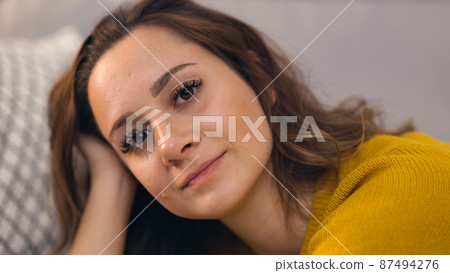 Young pretty woman immersed in thoughts Young pretty woman immersed in thoughts 87494276