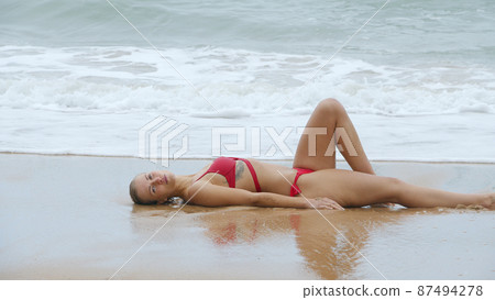 Young and sexy woman at the beach Young and sexy woman at the beach 87494278