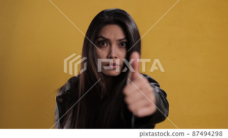 Young confident woman against a neutral background Young confident woman against a neutral background 87494298