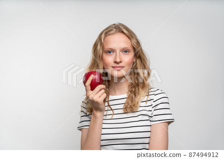 Portrait of young smiling woman with red apple. Fresh face, natural beauty Portrait of young smiling woman with red apple. Fresh face, natural beauty 87494912
