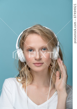 Closeup vertical portrait of young woman closed eyes listening music 87494921