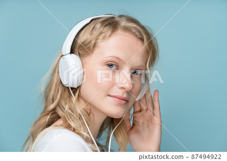 Closeup portrait of side view young woman closed eyes listening music 87494922