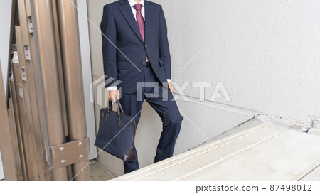 Image of a businessman climbing stairs Image of a businessman climbing stairs 87498012